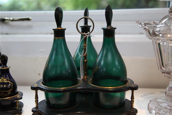 A Regency gilt decorated green glass three bottle decanter stand, total height 26cm